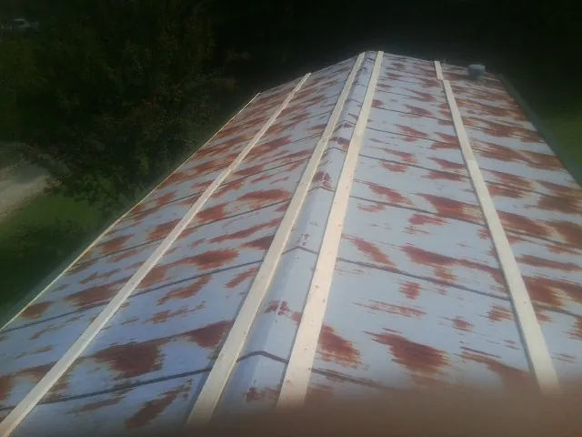 Rusted metal roof panels with new wood purlins before replacement — Storm Damage Roof Repair in Mount Horeb by Roofing Brothers