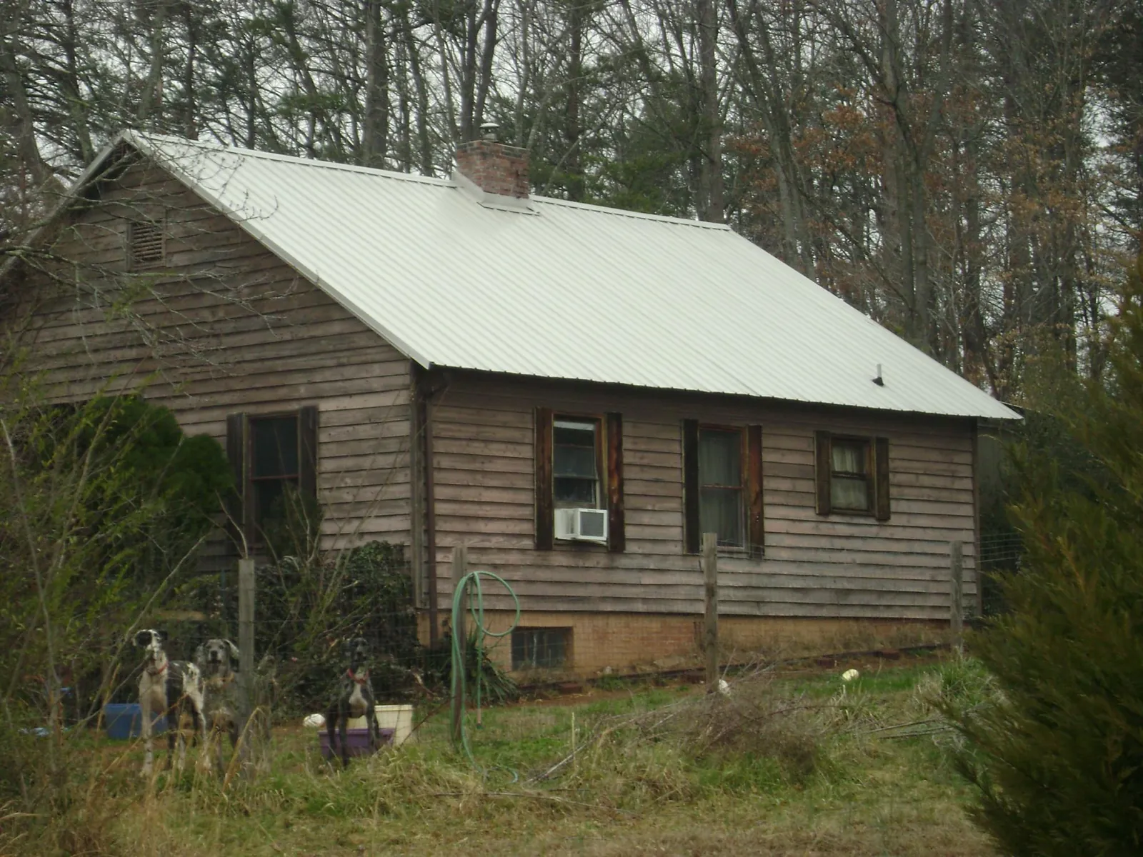 White metal roof on an old wood sided farmhouse, from a Metal Roof Installation job in Mount Horeb